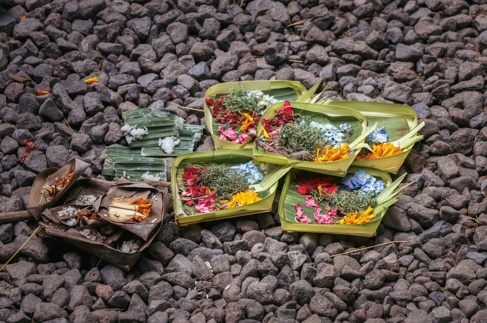 A pile of flowers sitting on top of a pile of rocks